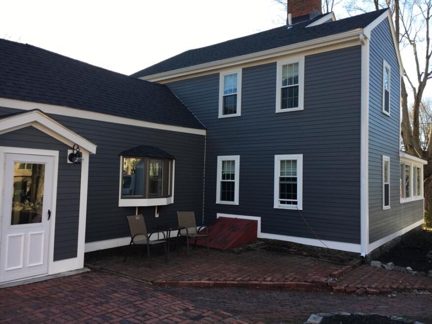 newly renovated house with blue exterior siding