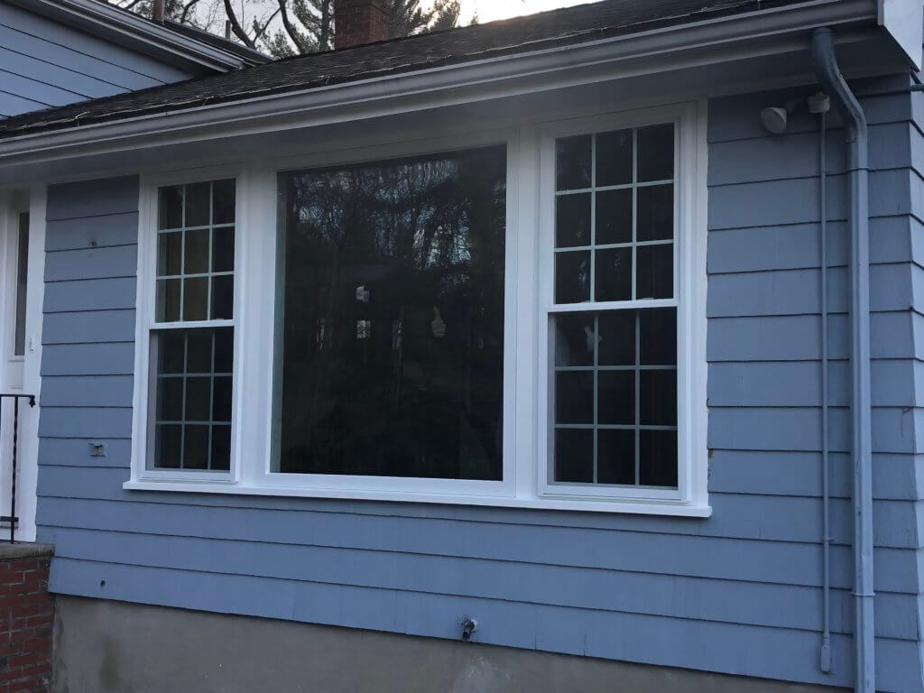 After photo of Lynnfield replacement with picture window flanked by two double-hung windows